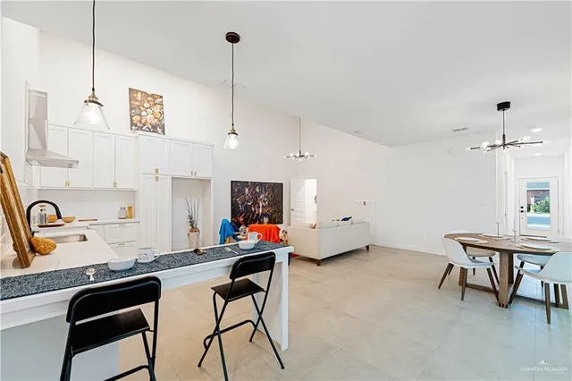 a room with stainless steel appliances kitchen island granite countertop furniture and a kitchen view