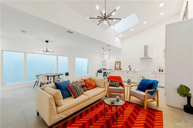 a living room with furniture and a chandelier