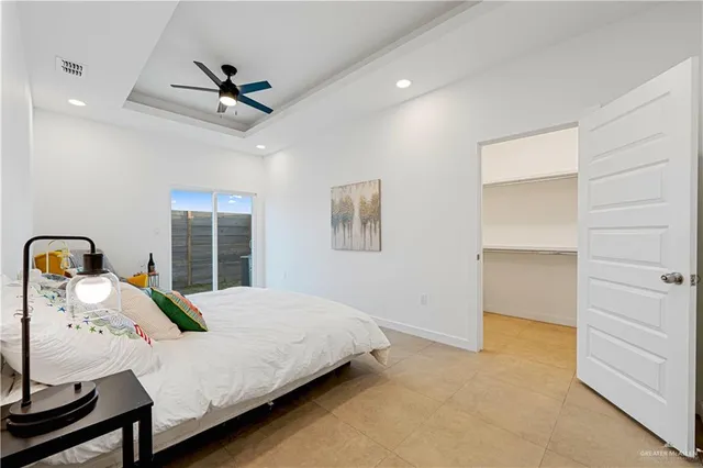 a bed room with a bed and a ceiling fan