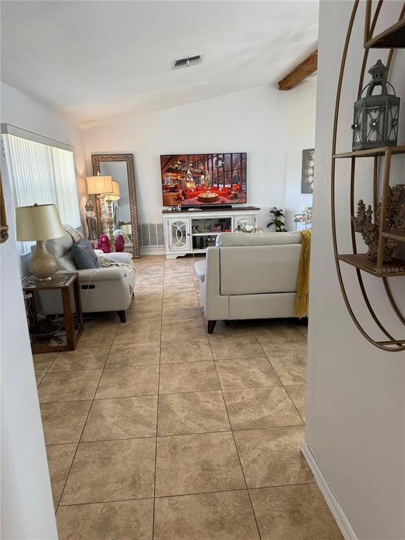 5389 Frost Road Spring Hill, FL 34606 - Photo 17 of 60 a living room with furniture and a flat screen tv