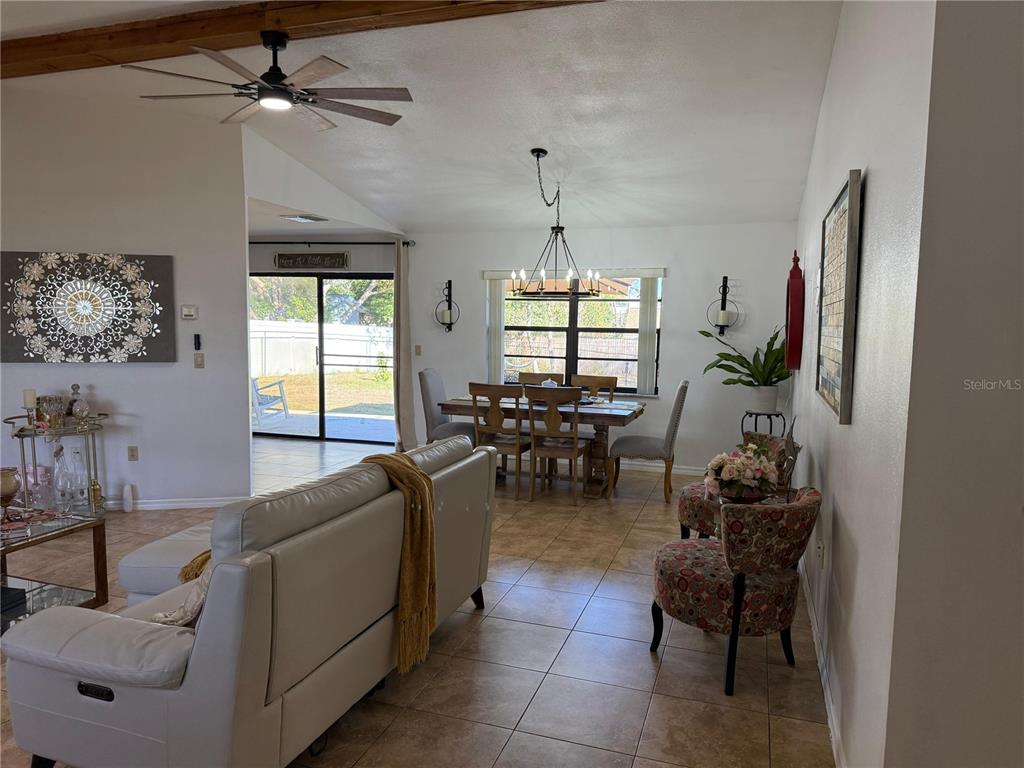 5389 Frost Road Spring Hill, FL 34606 - Photo 18 of 60 a living room with furniture and a chandelier
