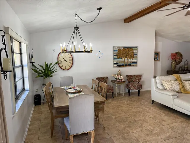 a view of a dining room with furniture and window