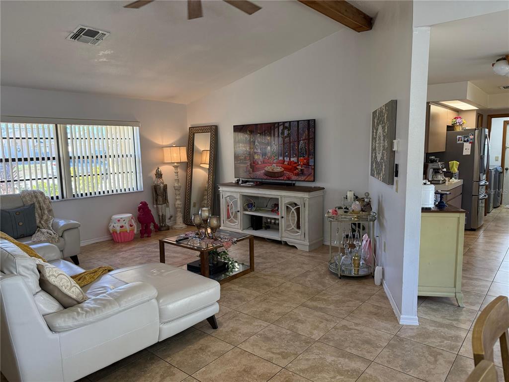 5389 Frost Road Spring Hill, FL 34606 - Photo 24 of 60 a living room with furniture a flat screen tv and a fireplace