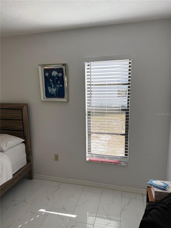 5389 Frost Road Spring Hill, FL 34606 - Photo 30 of 60 a bedroom with a bed and a window