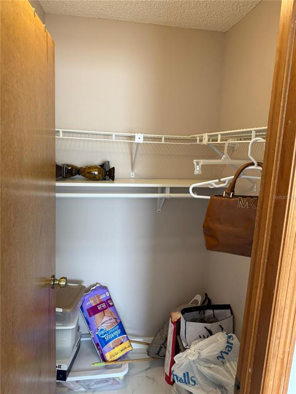 5389 Frost Road Spring Hill, FL 34606 - Photo 33 of 60 a view of storage and utility room with racks on the wall