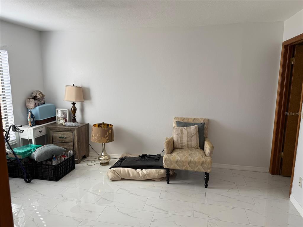 5389 Frost Road Spring Hill, FL 34606 - Photo 35 of 60 a bedroom with furniture and a couch