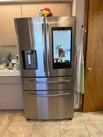 a kitchen with stainless steel appliances granite countertop a refrigerator a stove top oven a sink and dishwasher