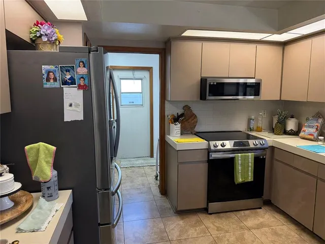 a kitchen with a sink appliances and cabinets