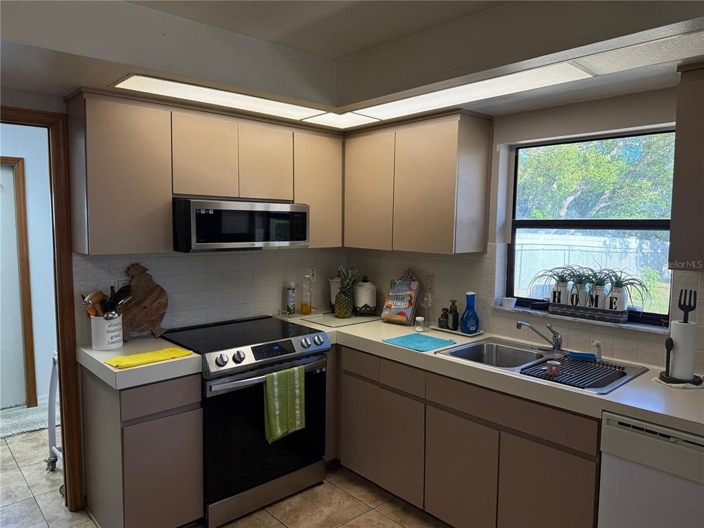 5389 Frost Road Spring Hill, FL 34606 - Photo 42 of 60 a kitchen with a sink stove top oven and cabinets