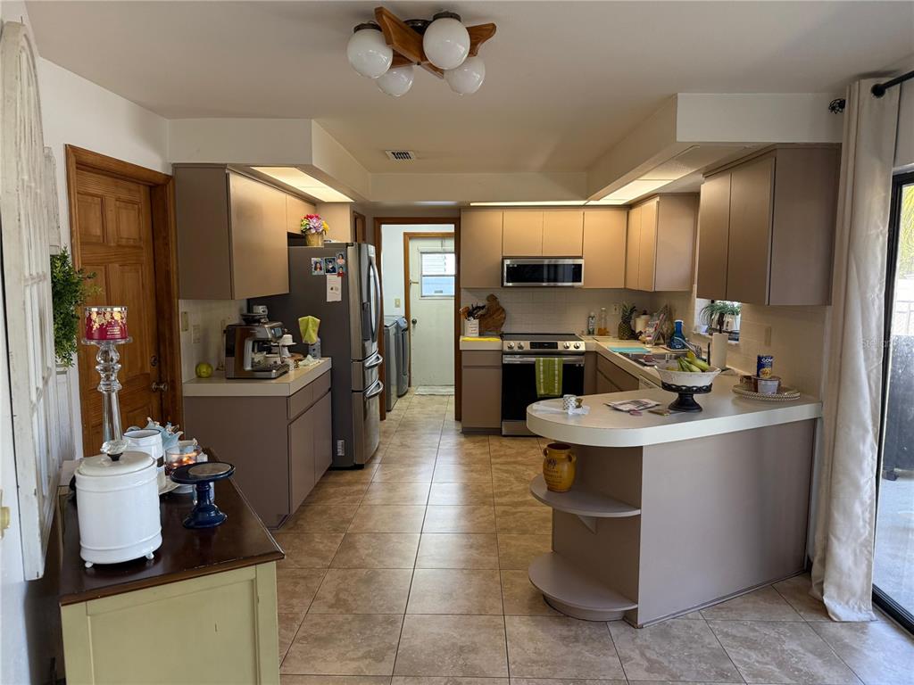 5389 Frost Road Spring Hill, FL 34606 - Photo 43 of 60 a kitchen with a sink appliances and cabinets