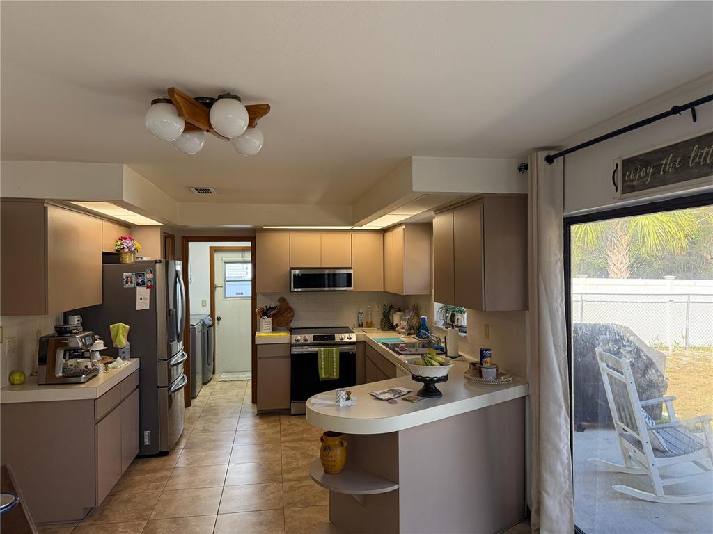 5389 Frost Road Spring Hill, FL 34606 - Photo 46 of 60 a kitchen with a sink appliances and cabinets