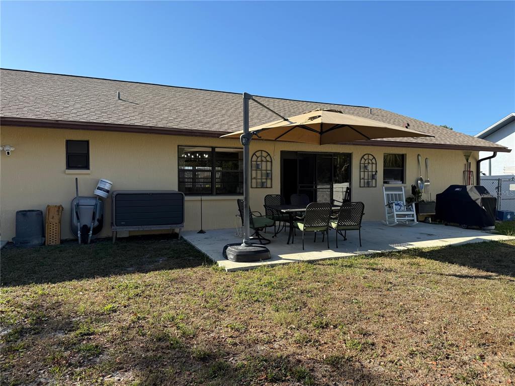 5389 Frost Road Spring Hill, FL 34606 - Photo 59 of 60 a view of a patio with a table and chairs under an umbrella