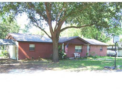 4785 Castlewood Road Seffner, FL 33584 - Photo 1 of 1 a large house with a tree in front of it