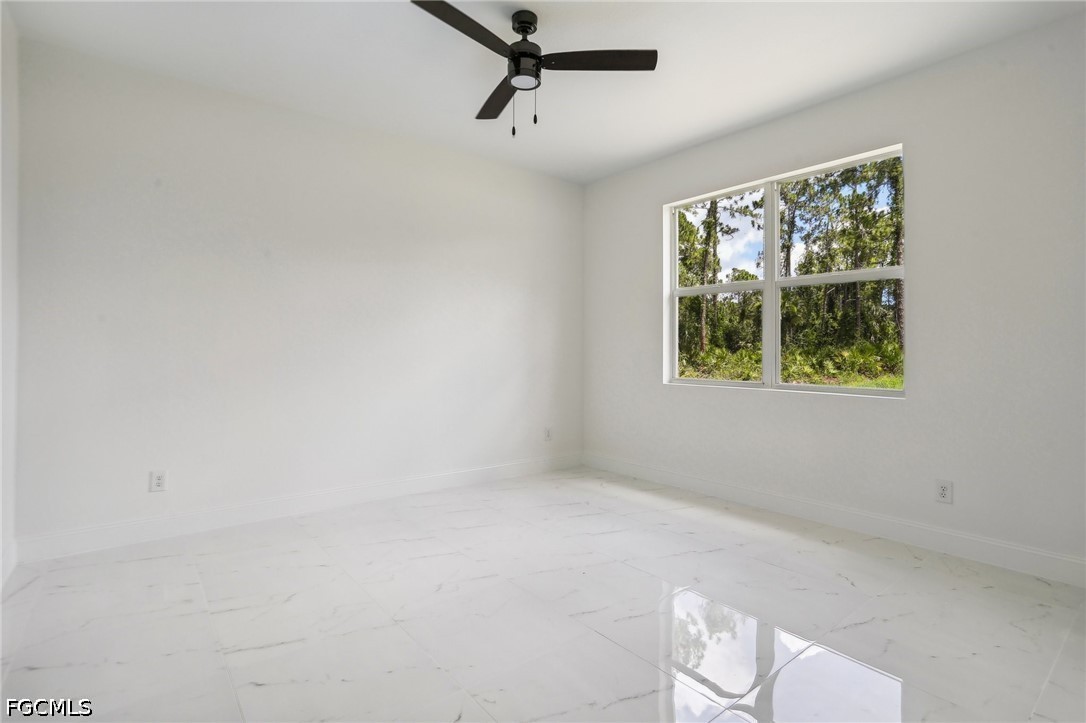3408 14th Street Southwest Lehigh Acres, FL 33976 - Photo 12 of 24 a view of a room with a window