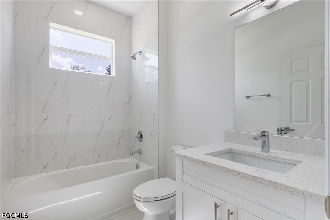 3408 14th Street Southwest Lehigh Acres, FL 33976 - Photo 24 of 24 a bathroom with a sink a toilet and shower