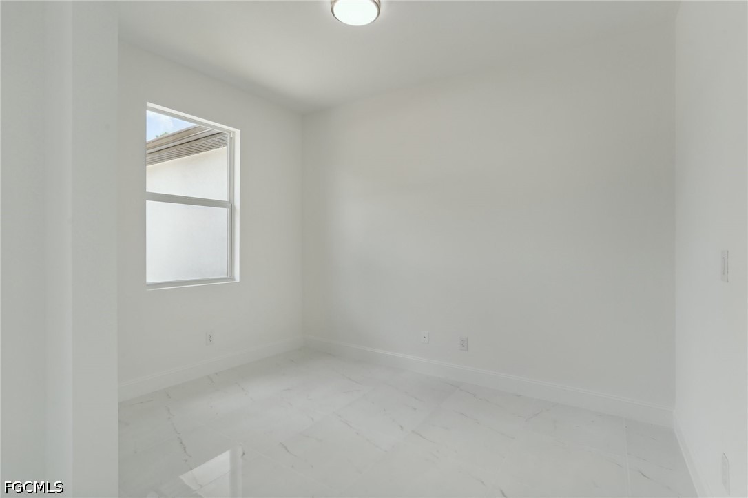 3408 14th Street Southwest Lehigh Acres, FL 33976 - Photo 8 of 24 a view of an empty room with a window