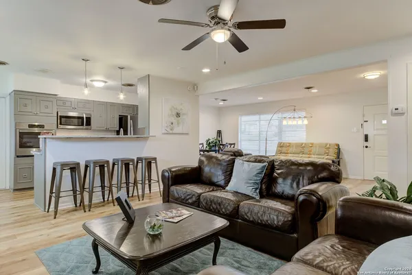 a living room with furniture and a view of kitchen