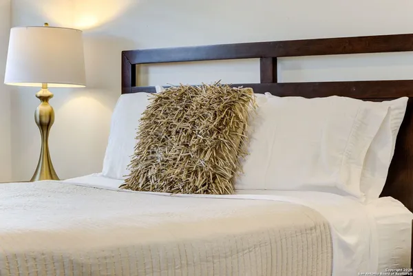 a bedroom with a bed and a lamp