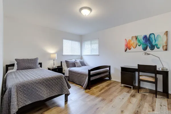 a bedroom with a bed and a desk