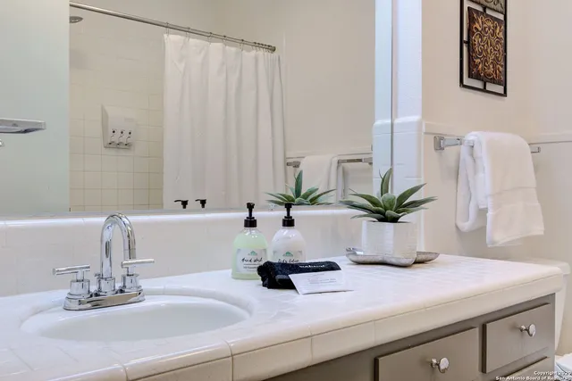 a bathroom with a sink a vanity and a mirror