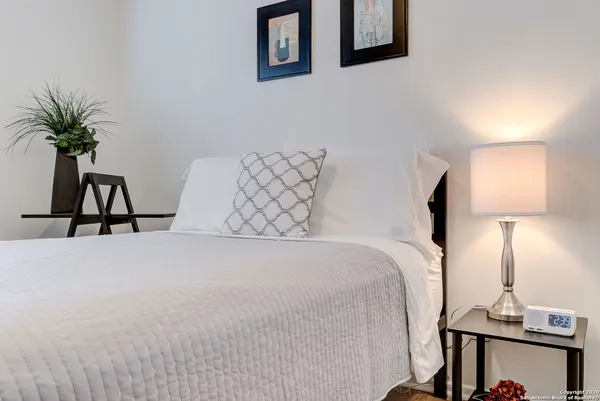 a bed room with a bed and a night stand