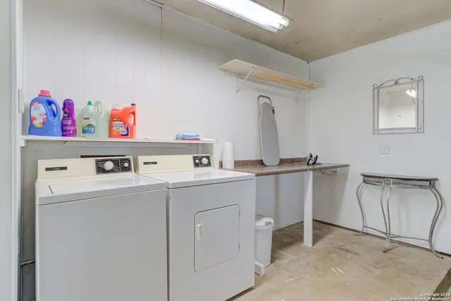a storage room with cabinets washer and dryer