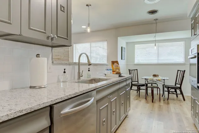 a kitchen with center island table and chairs
