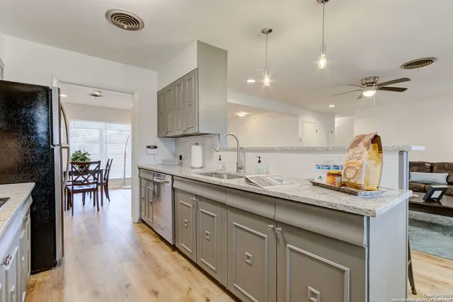 a kitchen with sink stove and cabinets