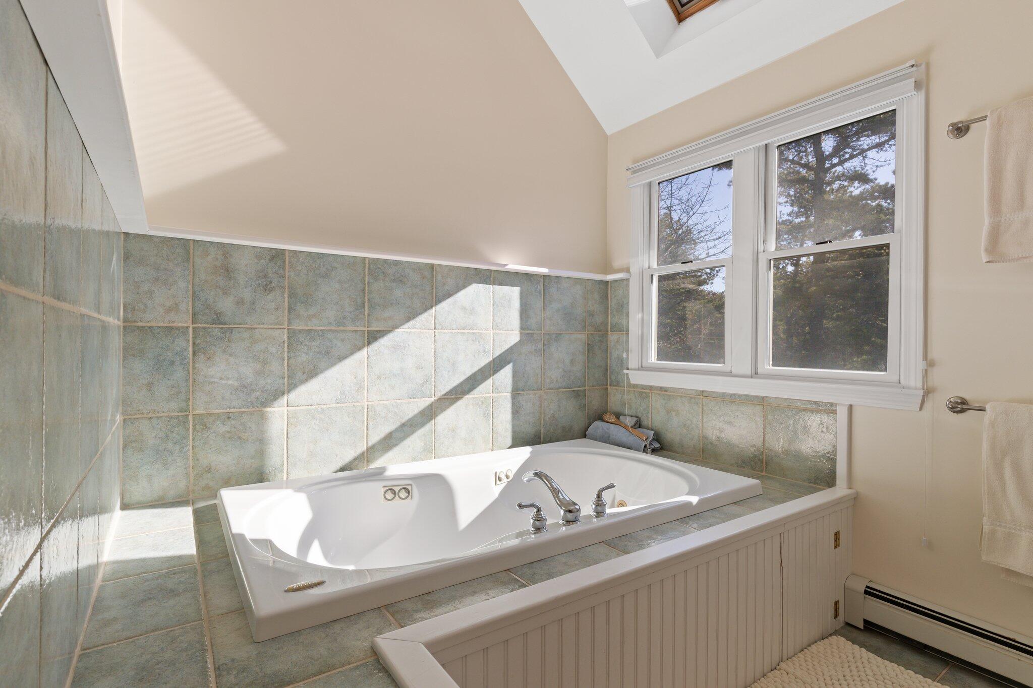 11 Sandy Lane Truro, MA 02666 - Photo 40 of 98 a bath tub sitting in a bathroom next to a window