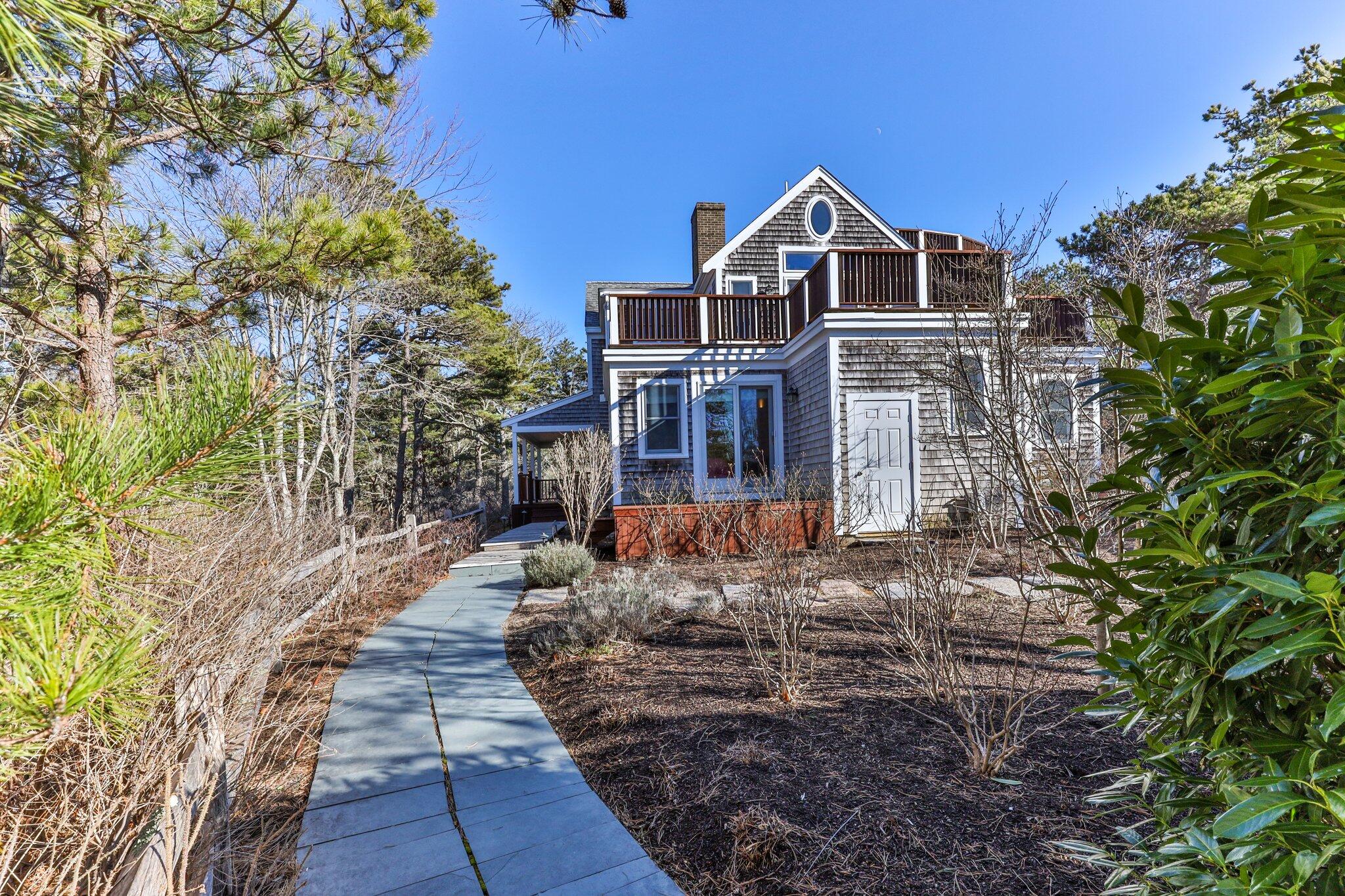 11 Sandy Lane Truro, MA 02666 - Photo 7 of 98 a front view of a house with a yard