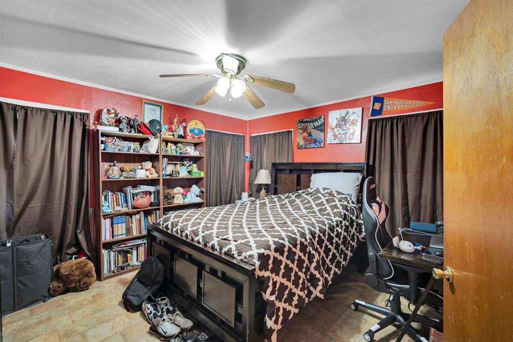 846 Truman Circle Lancaster, TX 75146 - Photo 11 of 29 a bedroom with a large bed and a bookshelf