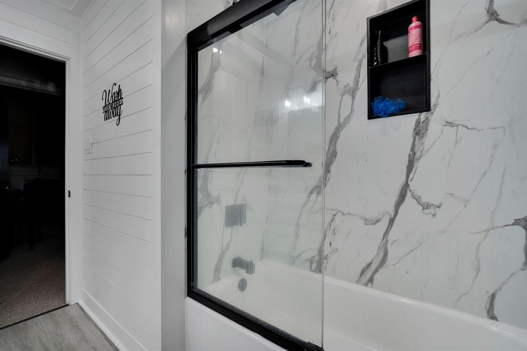 846 Truman Circle Lancaster, TX 75146 - Photo 13 of 29 a bathroom with a bathtub and a shower