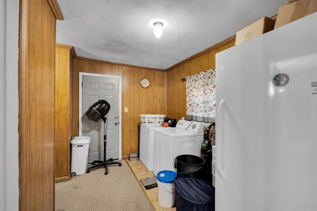 a room with a table chairs and a window