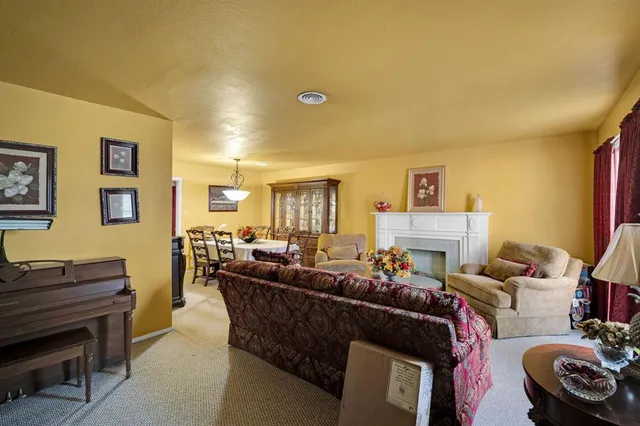 a view of a dining room with furniture and window