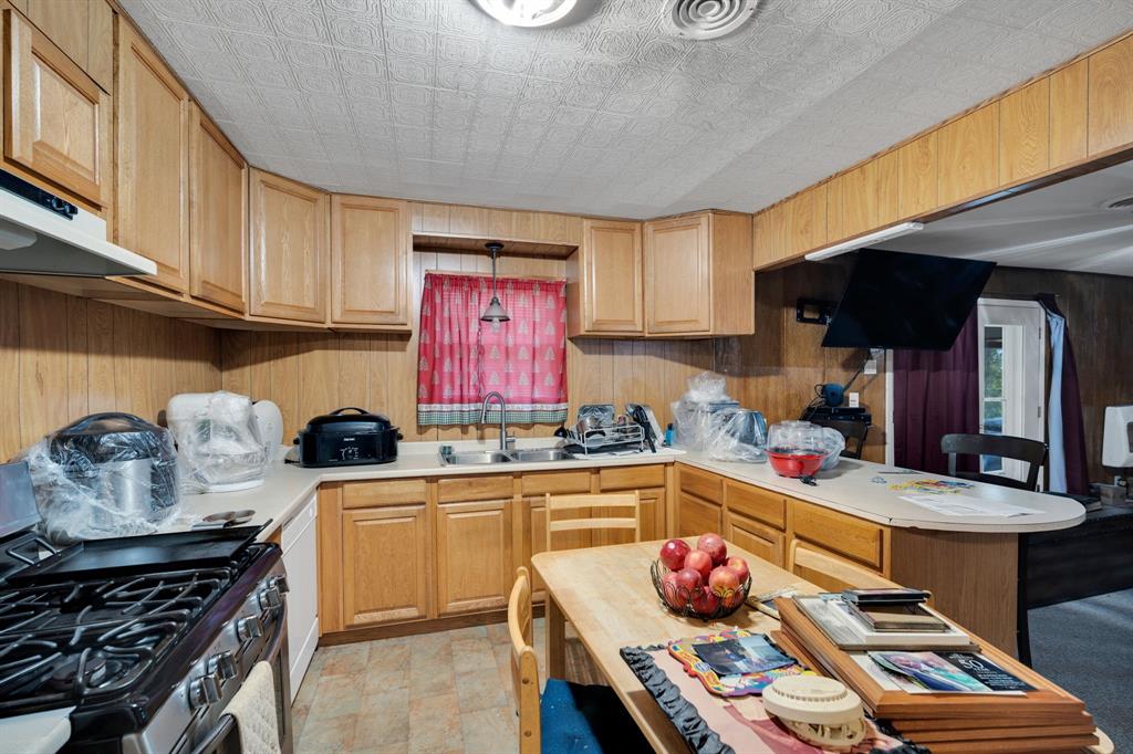 846 Truman Circle Lancaster, TX 75146 - Photo 26 of 29 a kitchen with stainless steel appliances kitchen island granite countertop a sink stove and cabinets