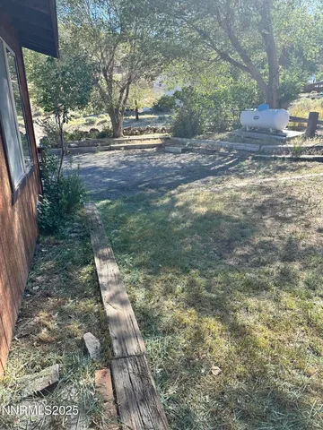 a view of a yard with a car parked