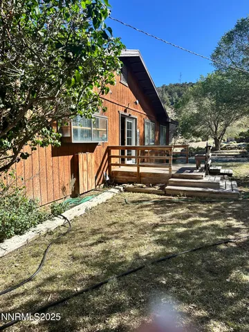 a backyard of a house with table and chairs