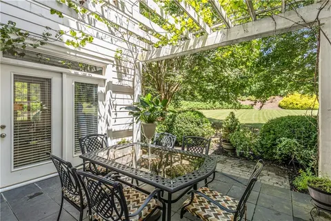 a view of a patio that has couches chairs and a potted plant