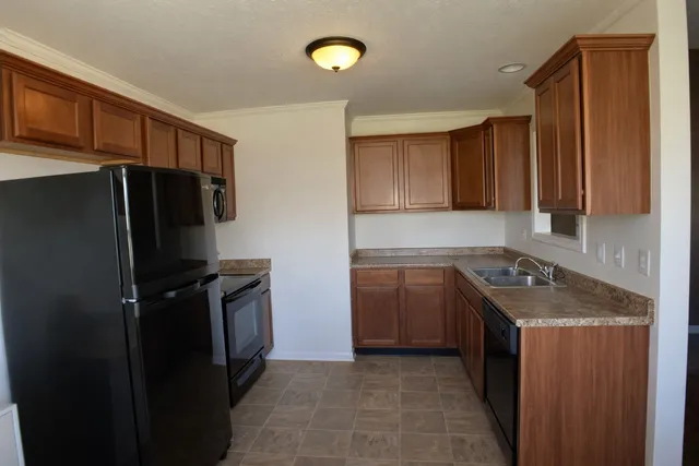 a kitchen with a refrigerator and a sink