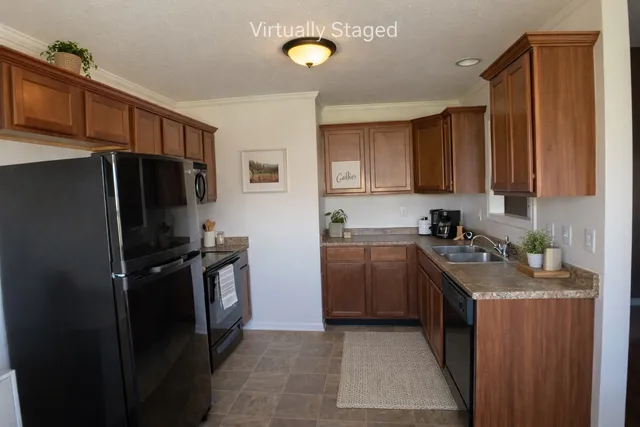 a kitchen with stainless steel appliances granite countertop a refrigerator stove and sink