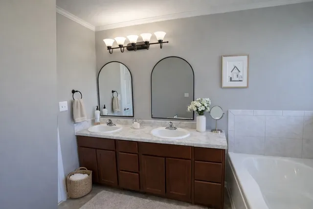 a bathroom with a double vanity sink and a bathtub