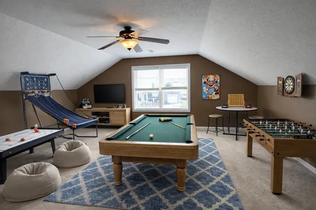 a living room with furniture a piano and a flat screen tv