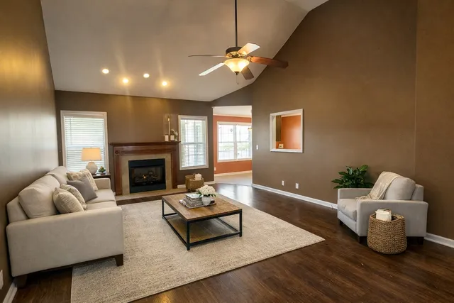 a living room with furniture and a fireplace
