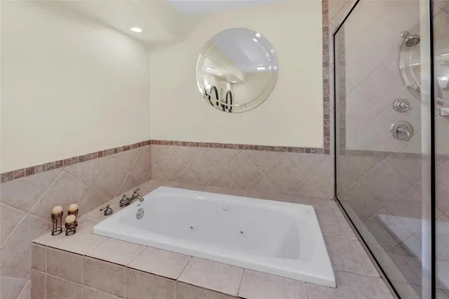 a bathroom with a tub and a shower