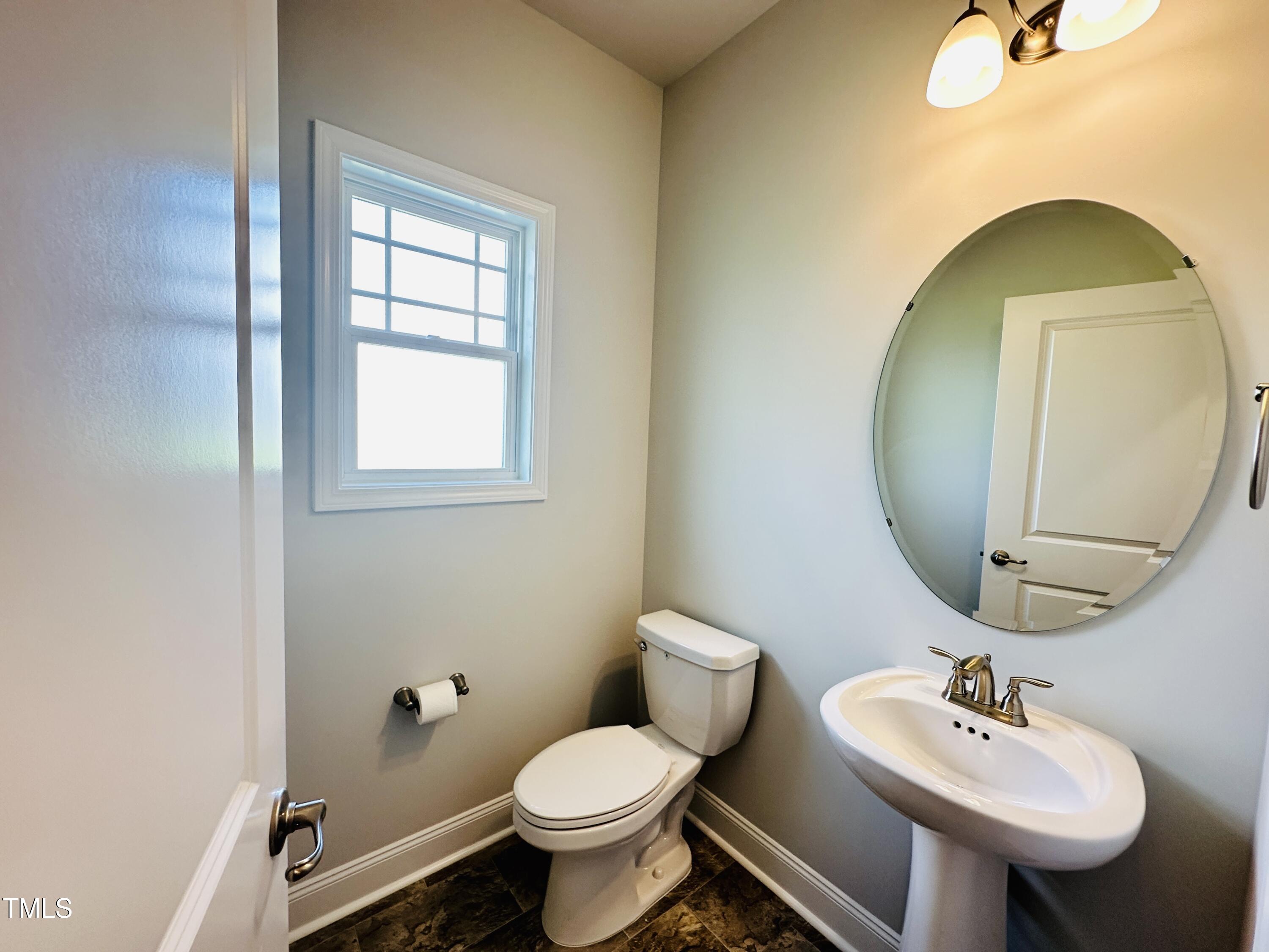 3982 Fletcher Road Bailey, NC 27807 - Photo 11 of 28 a bathroom with a toilet sink and mirror