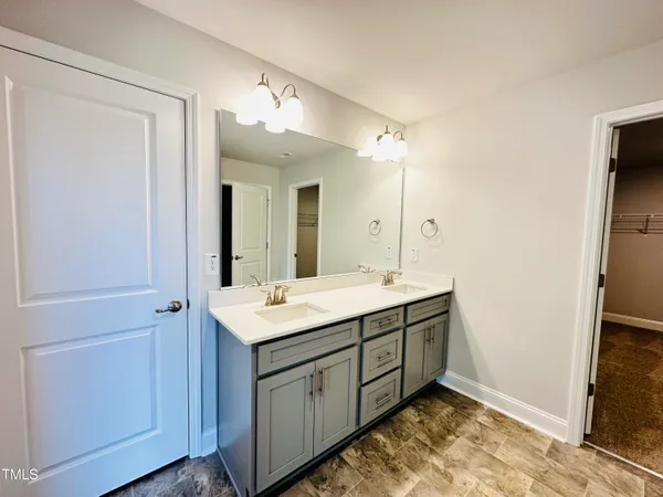 a bathroom with a double vanity sink and mirror