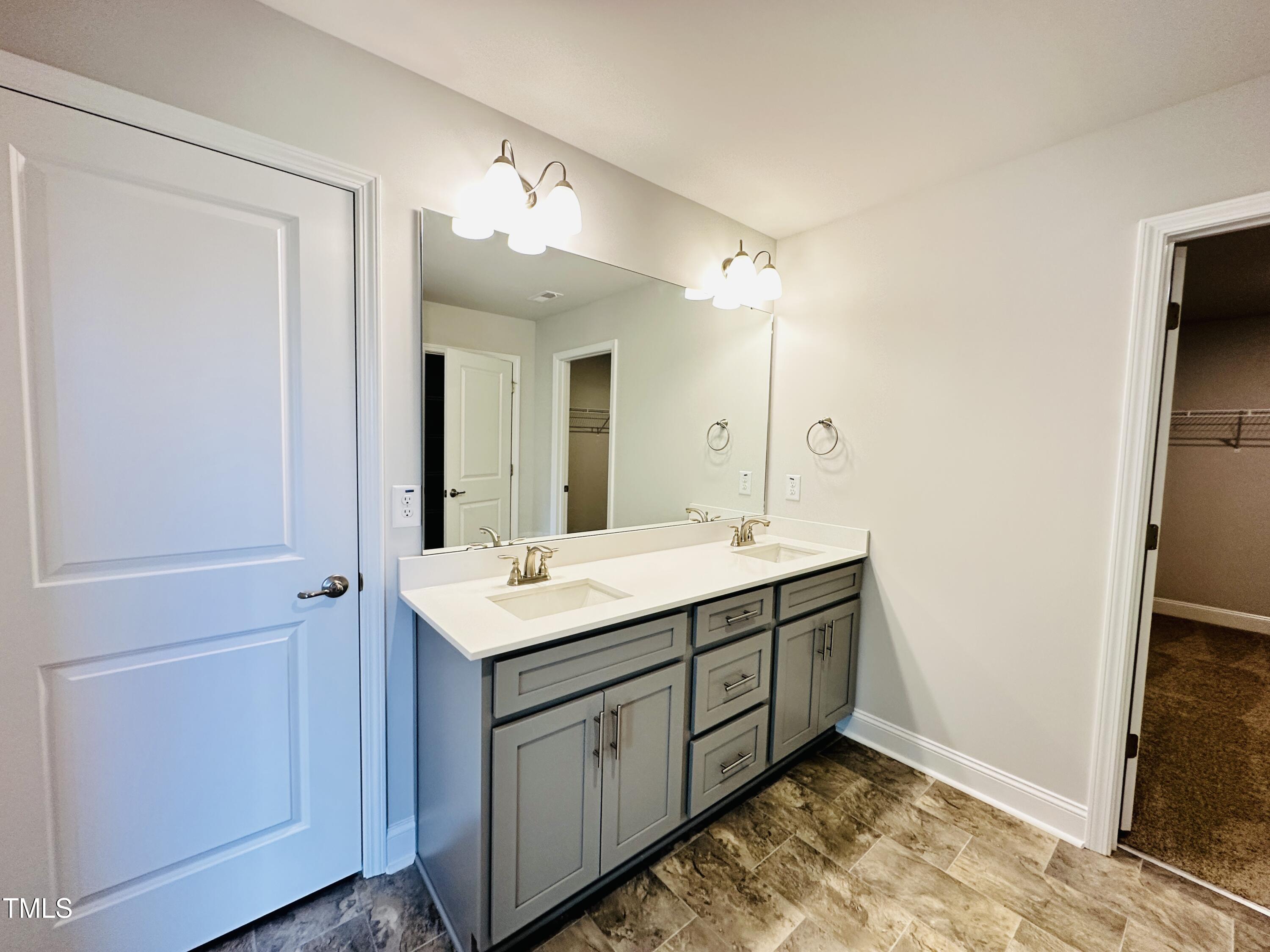 3982 Fletcher Road Bailey, NC 27807 - Photo 20 of 28 a bathroom with a double vanity sink and mirror