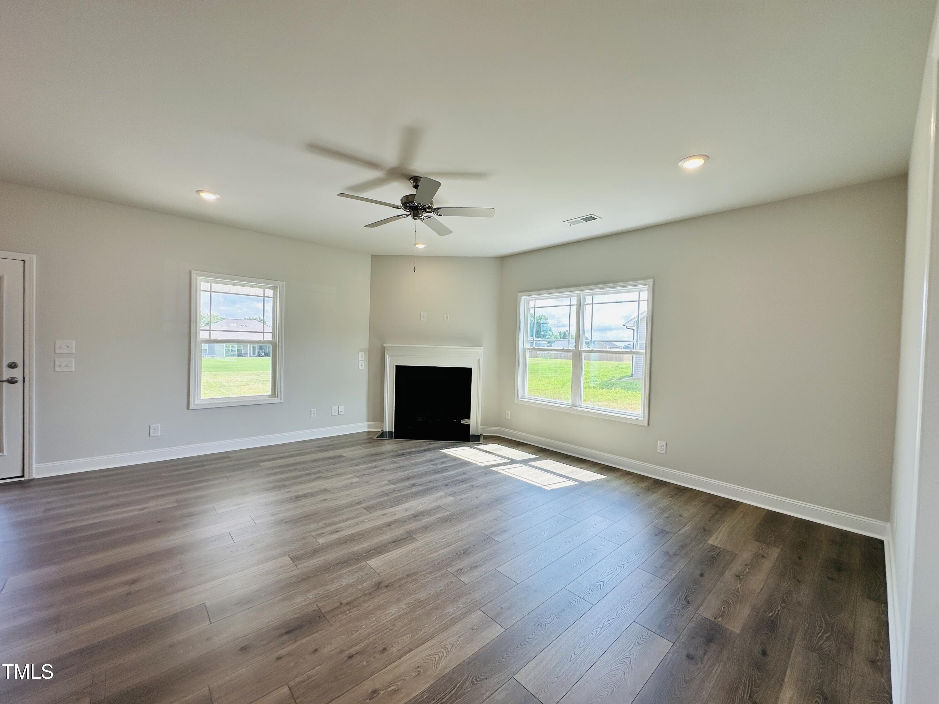 3982 Fletcher Road Bailey, NC 27807 - Photo 4 of 28 a view of an empty room with wooden floor and a window