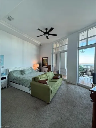 a living room with furniture and a ceiling fan