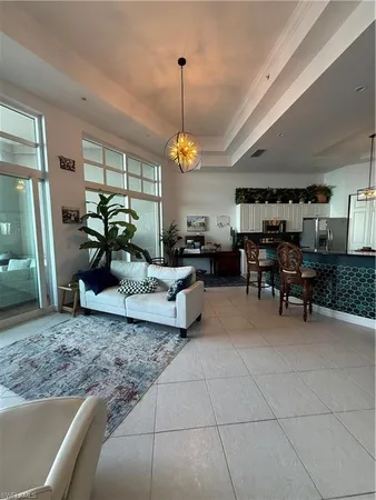a living room with lots of furniture and a chandelier